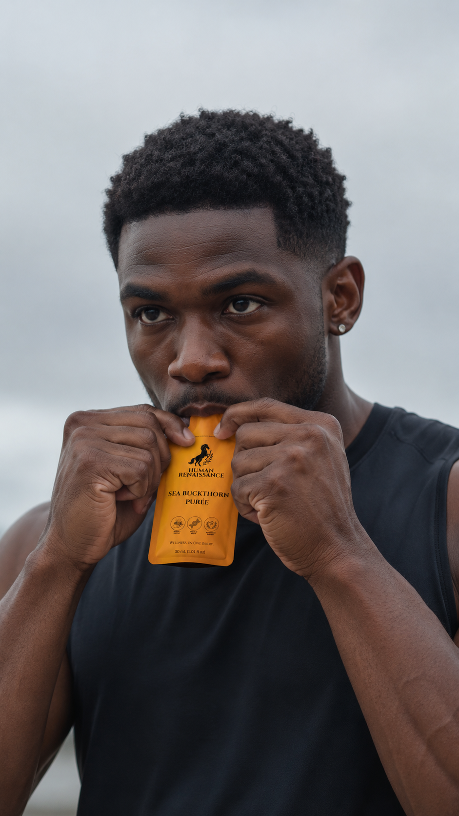 Man enjoying Human Renaissance Sea Buckthorn Puree pouch outdoors