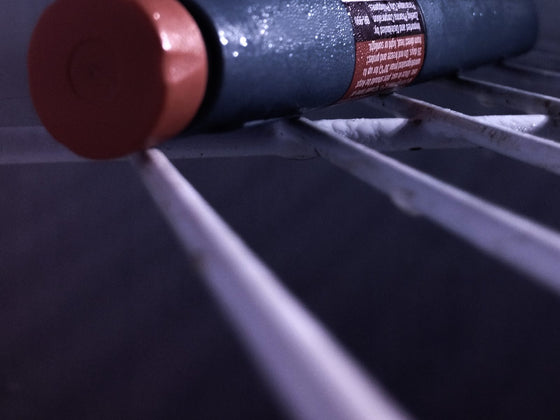 GLP-1 injection pen resting in a refrigerator door, representing GLP-1 agonist therapy