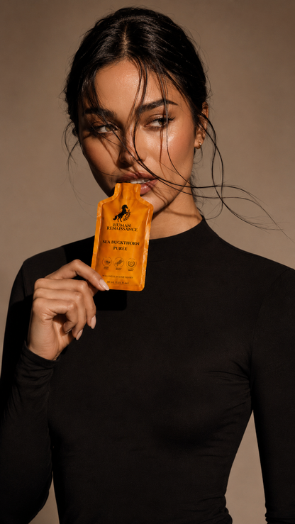 Woman holding Sea Buckthorn Puree pouch, editorial portrait